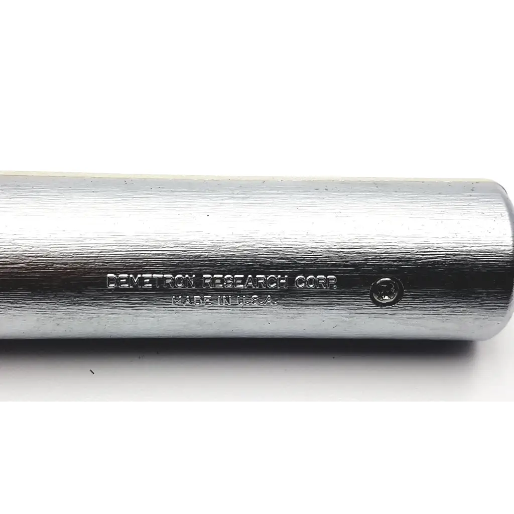 Silver cylindrical metal rod with brushed finish engraved demetron research corp and made in usa for demetron digilog electronic pulp tester