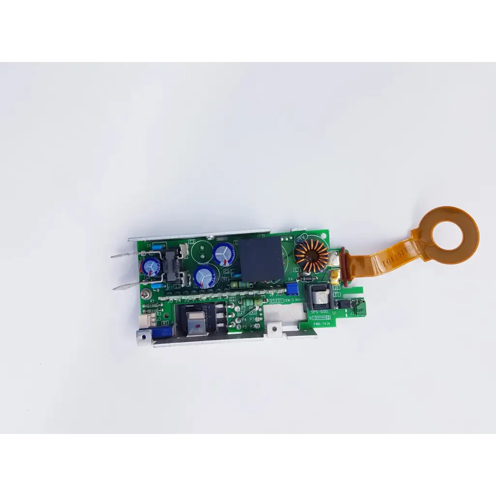 Green circuit board of densei-lambda alpha 600 power module with blue capacitors and orange ribbon cable for nibp assembly board