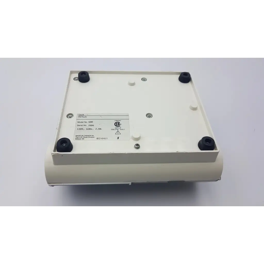 Cream-colored rectangular densply promix 400 dental amalgamator mixing system with black rubber feet and model label
