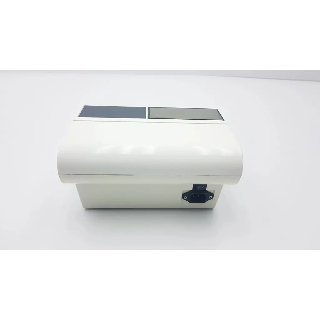 White rectangular densply promix 400 dental amalgamator mixing system with two gray panels and black power port side view