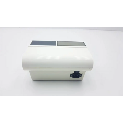 White rectangular densply promix 400 dental amalgamator mixing system with two gray panels and black power port side view