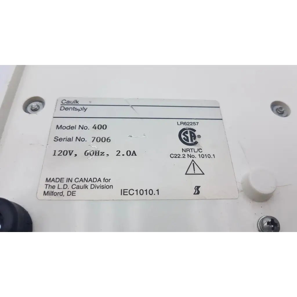 White rectangular label with black text on densply promix 400 dental amalgamator mixing system electrical device back side