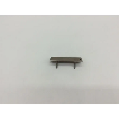 Silver metal drawer pull with two pointed prongs and flat rectangular plate for DePuy femoral component trials