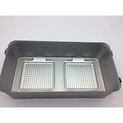 Gray rectangular DePuy Synthes sterilization container two level with perforated metal inserts and solid base