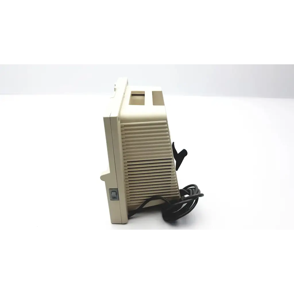 Beige plastic vintage devilbiss pulmoaide compressor monitor with vertical slatted vents and black power cord visible