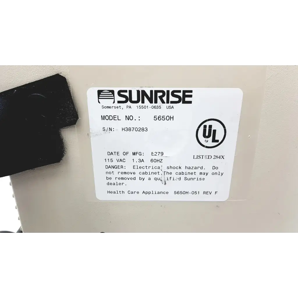 White rectangular label with black text and logo on devilbiss pulmoaide compressor nebulizer 5650h device