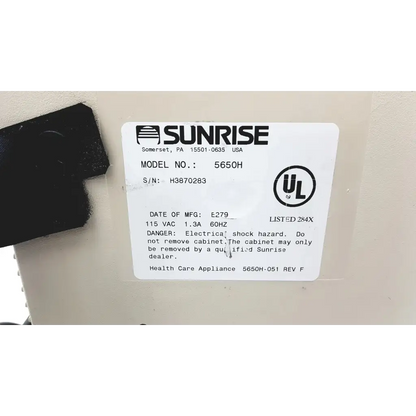 White rectangular label with black text and logo on devilbiss pulmoaide compressor nebulizer 5650h device