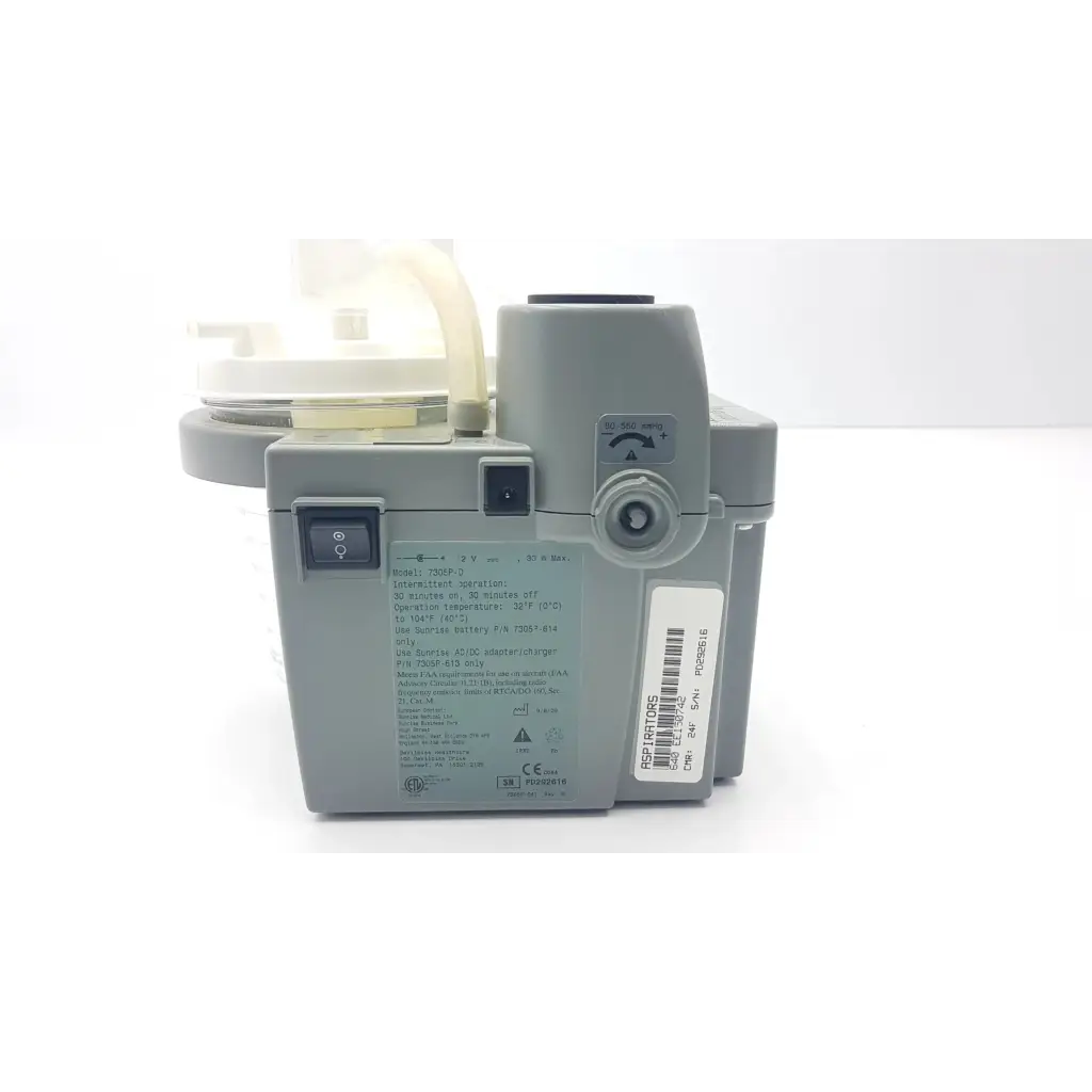 Gray DeVilbiss suction machine 7305p-d with translucent plastic tubing and labeled specifications for homecare use