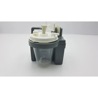 Gray and white DeVilbiss suction machine 7305p-d with transparent collection chamber and homecare suction unit accessories