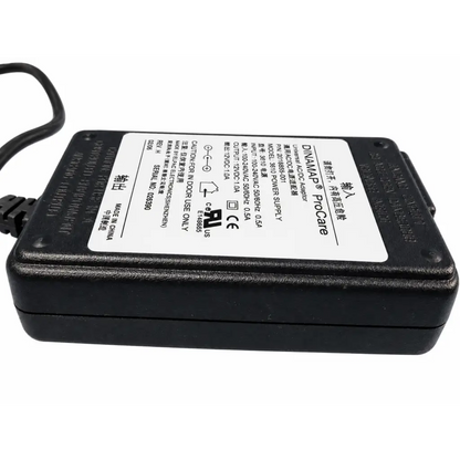 Black plastic dinamap procare universal ac dc power supply adapter with white label showing technical details back side