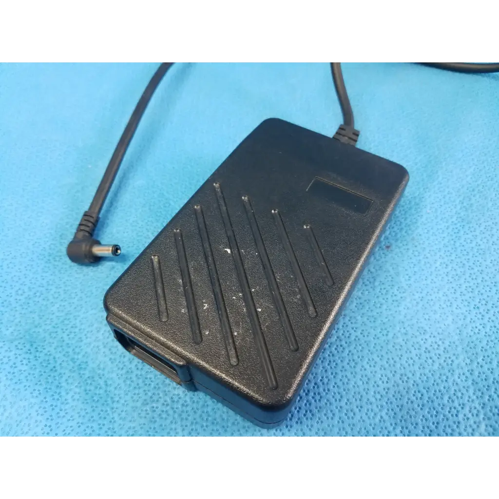 Black plastic power supply with textured surface and angled cable connector for dinamap procare 3610 adapter