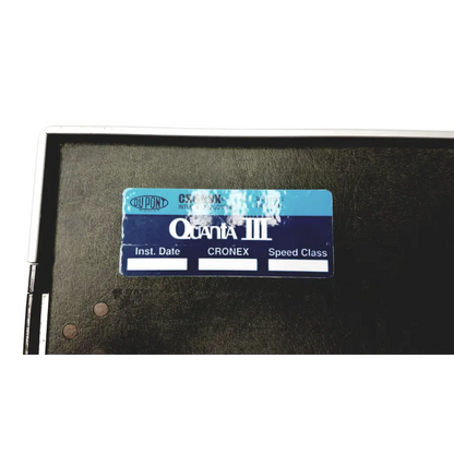 Blue and white label on dark surface identifying the dupont cronex quanta iii x-ray cassette 8x10 back side
