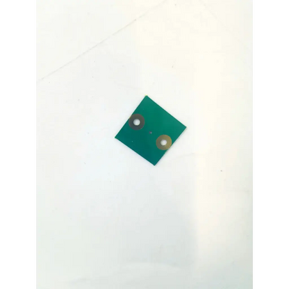 Green 1.25mm circuit board e142470 k750158.00 with two circular metallic pads for electronic applications