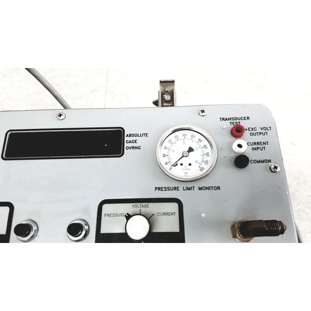 Silver metallic pressure limit monitor gauge with white face and black markings for pressure calibration standard in Eaton UPC5000 case