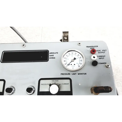 Silver metallic pressure limit monitor gauge with white face and black markings for pressure calibration standard in Eaton UPC5000 case