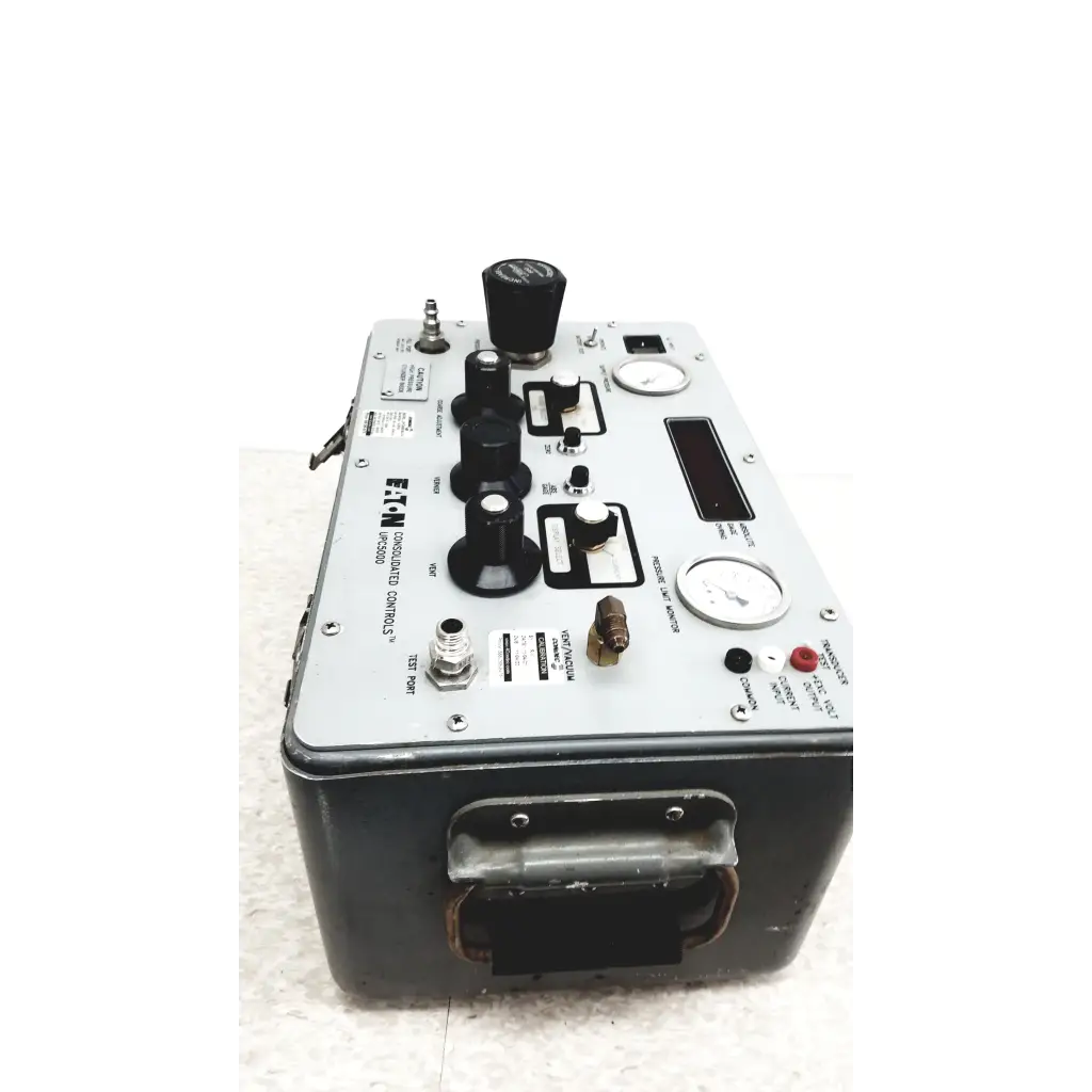 Gray metal Eaton UPC5000 pressure calibration standard with black knobs gauges and handle for industrial calibration use