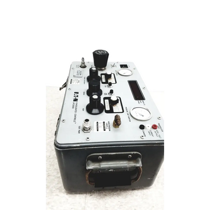 Gray metal Eaton UPC5000 pressure calibration standard with black knobs gauges and handle for industrial calibration use