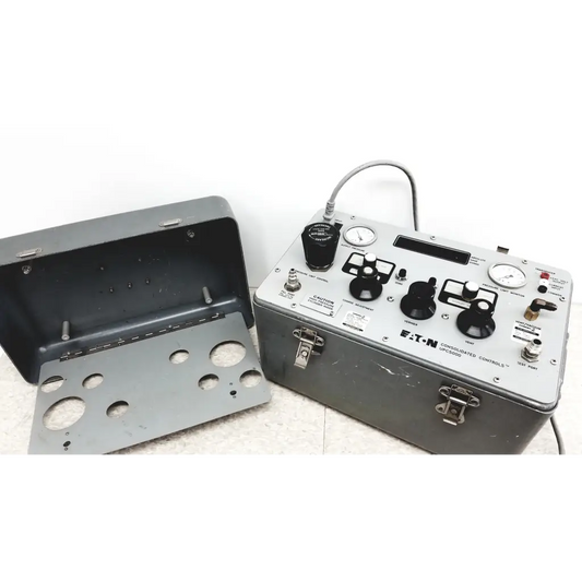 Gray metal eaton upc5000 pressure calibration standard box with black knobs gauges and coiled cable for calibration