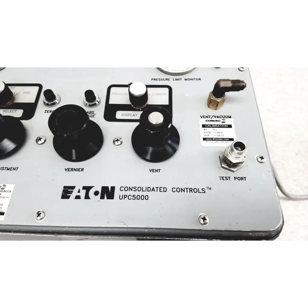 Silver metallic Eaton UPC5000 consolidated controls pressure calibration standard panel with black knobs and labeled dials