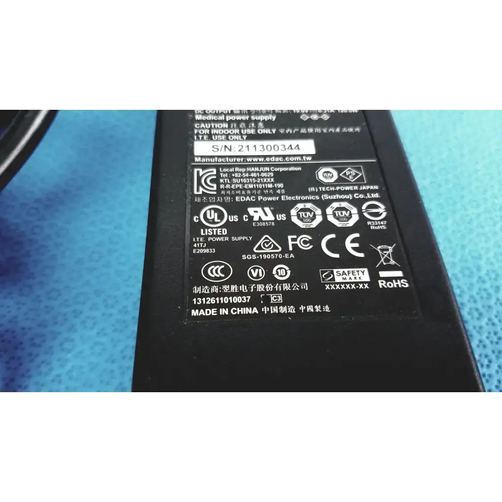 Black plastic edacpower elec em110111m-190 adapter power supply with white printed labels and certification marks