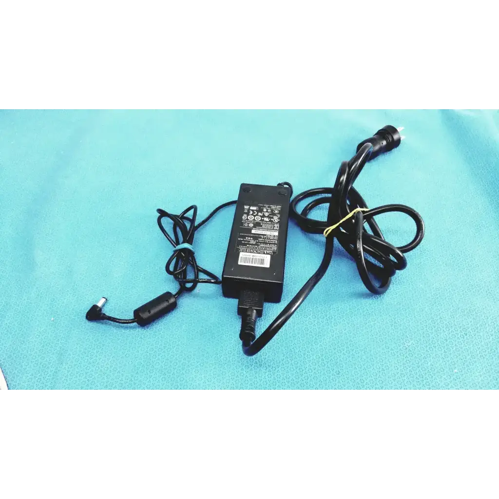 Black plastic edacpower elec em110111m-190 adapter power supply with coiled cord secured by a yellow tie
