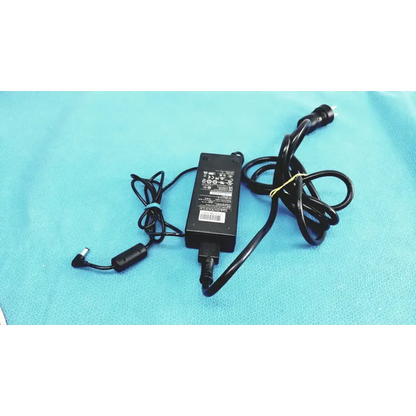 Black plastic edacpower elec em110111m-190 adapter power supply with coiled cord secured by a yellow tie