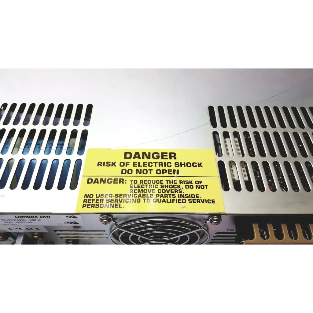 Yellow warning label on the back of electronic measurements ems power supply cautioning against electric shock risk