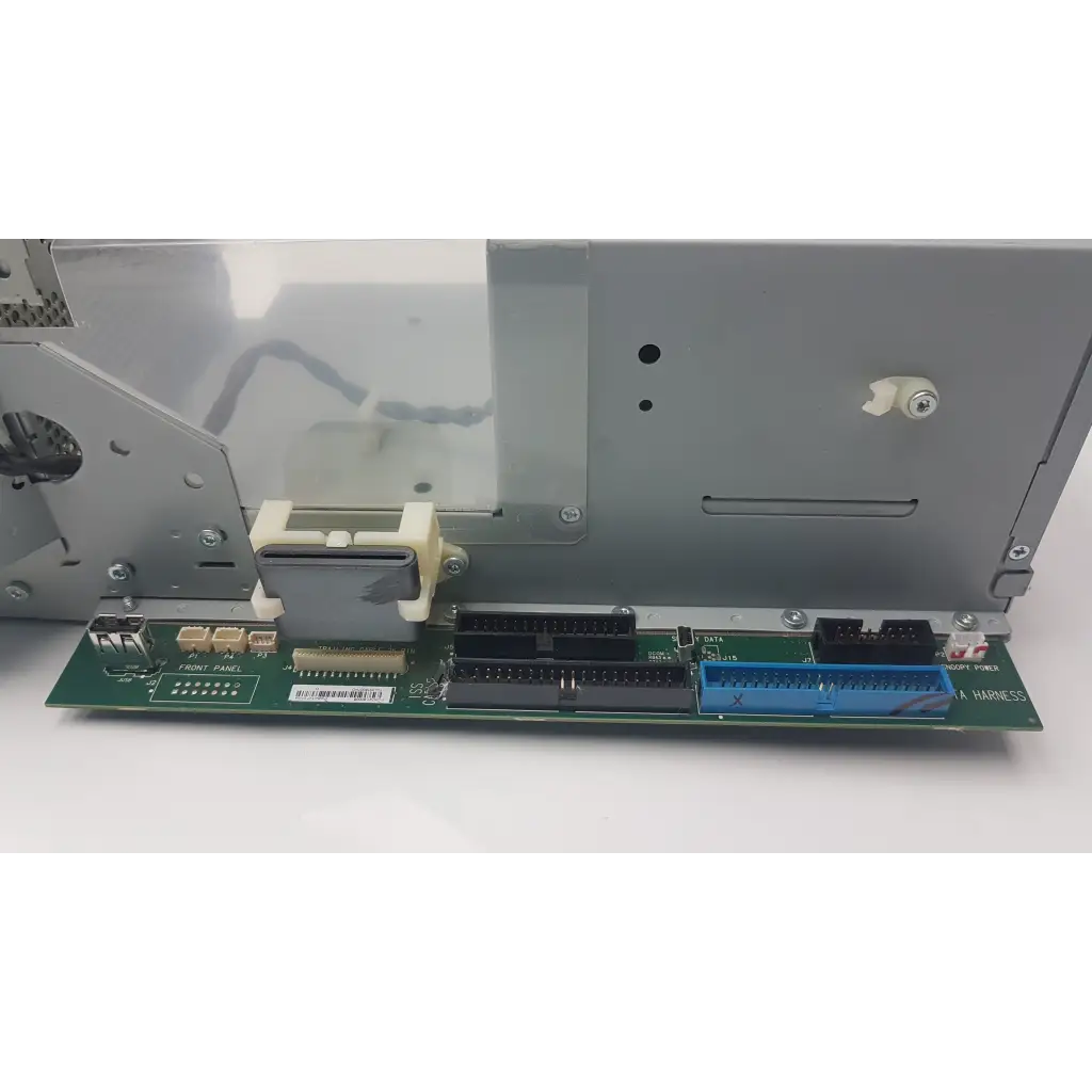 Green circuit board electronics module with black and blue connectors and beige plastic housing for power supply unit