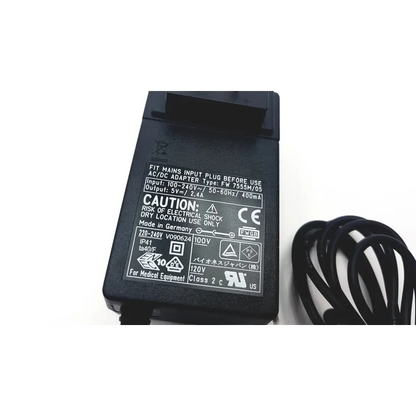 Black plastic ac/dc adapter with coiled cord labeled made in germany for medical use enteralite infinity fw7555m