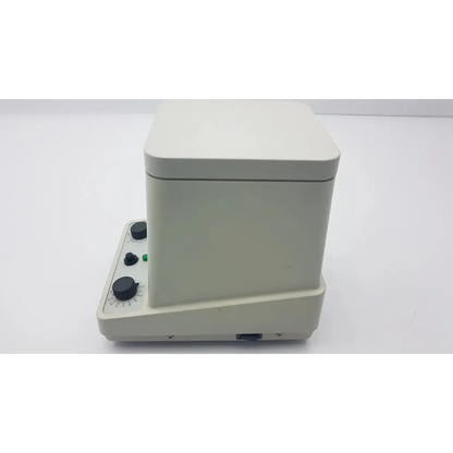 Off-white eppendorf 5415c analog centrifuge with three black rotary knobs and green indicator light on control panel