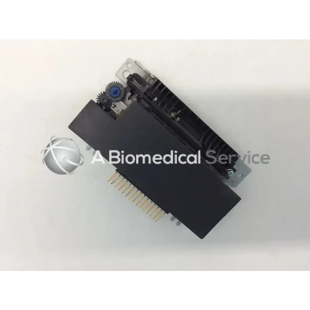 Black rectangular epson m-180 mini printer mechanism with metallic and blue gears and gold-colored printer mechanism needle pins