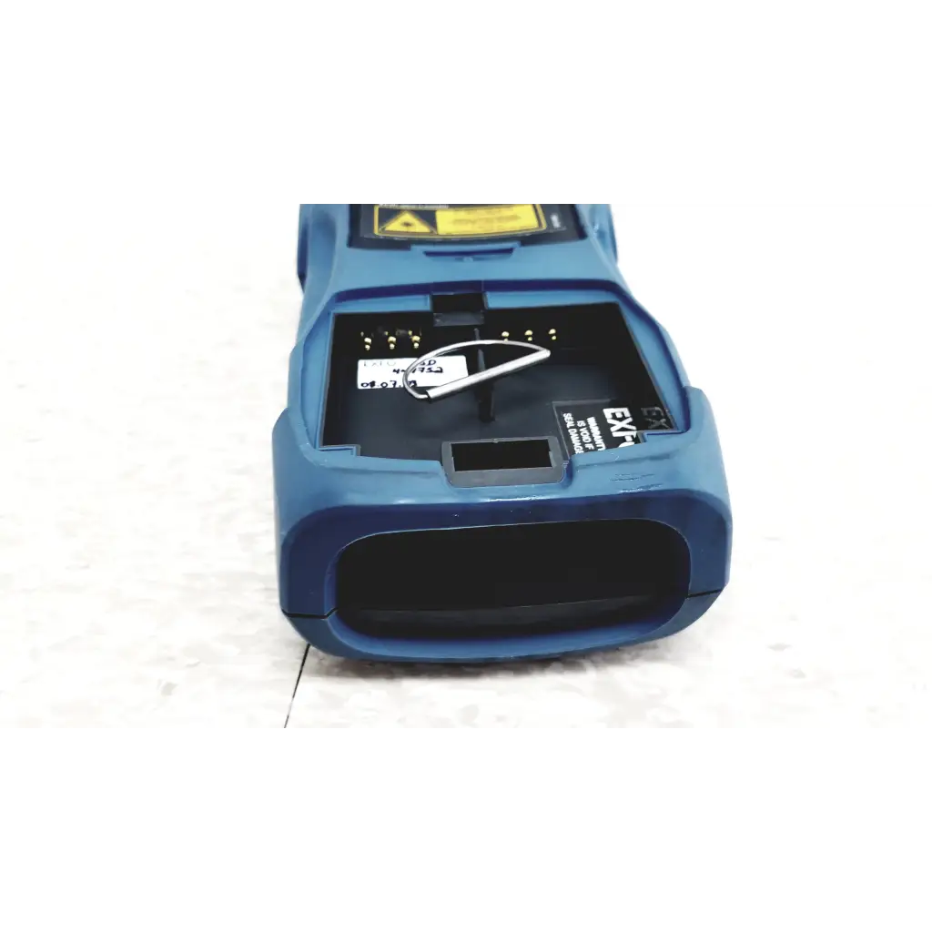 Blue plastic handheld exfo axs-100 optical time domain reflectometer with black interior and yellow warning label for fiber optic use