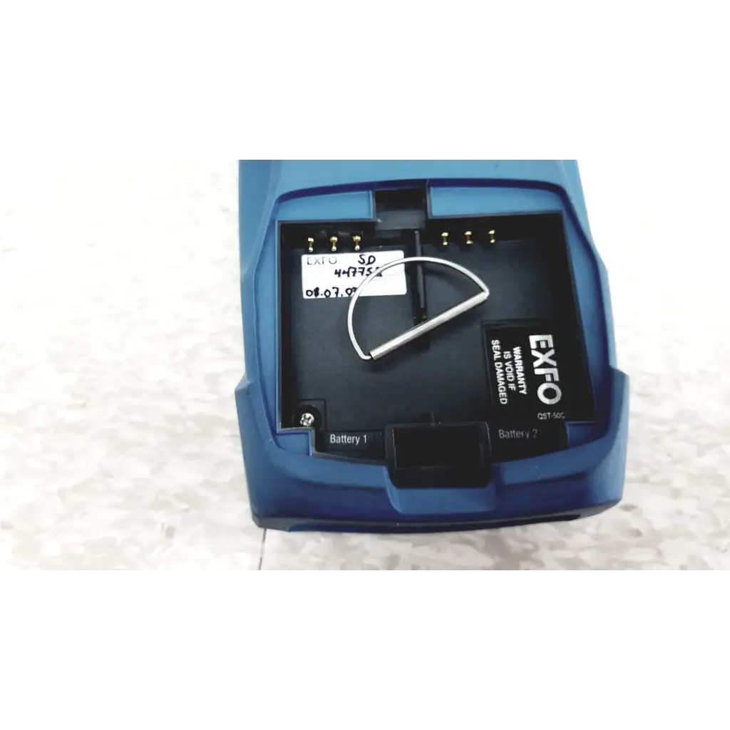 Blue exfo qst-50c battery charger with open compartment for two batteries used with exfo axs-100 optical time domain reflectometer