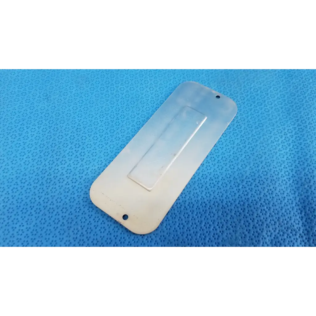 Transparent plastic external base mechanical interface trim cover plate with rectangular grip and attachment holes for topcon fundus camera