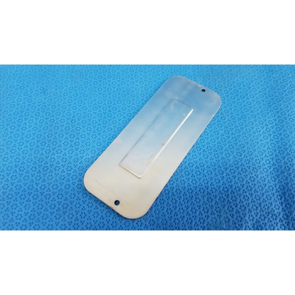 Transparent plastic external base mechanical interface trim cover plate with rectangular grip and attachment holes for topcon fundus camera