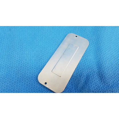 White rectangular plastic drawer pull with clear insert and two mounting holes for base mechanical interface trim plate