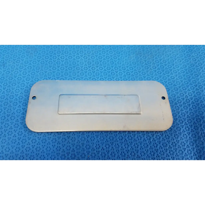 Silver rectangular metal external base mechanical interface trim cover plate with central recess and two top holes for topcon trc-nw8 fundus camera