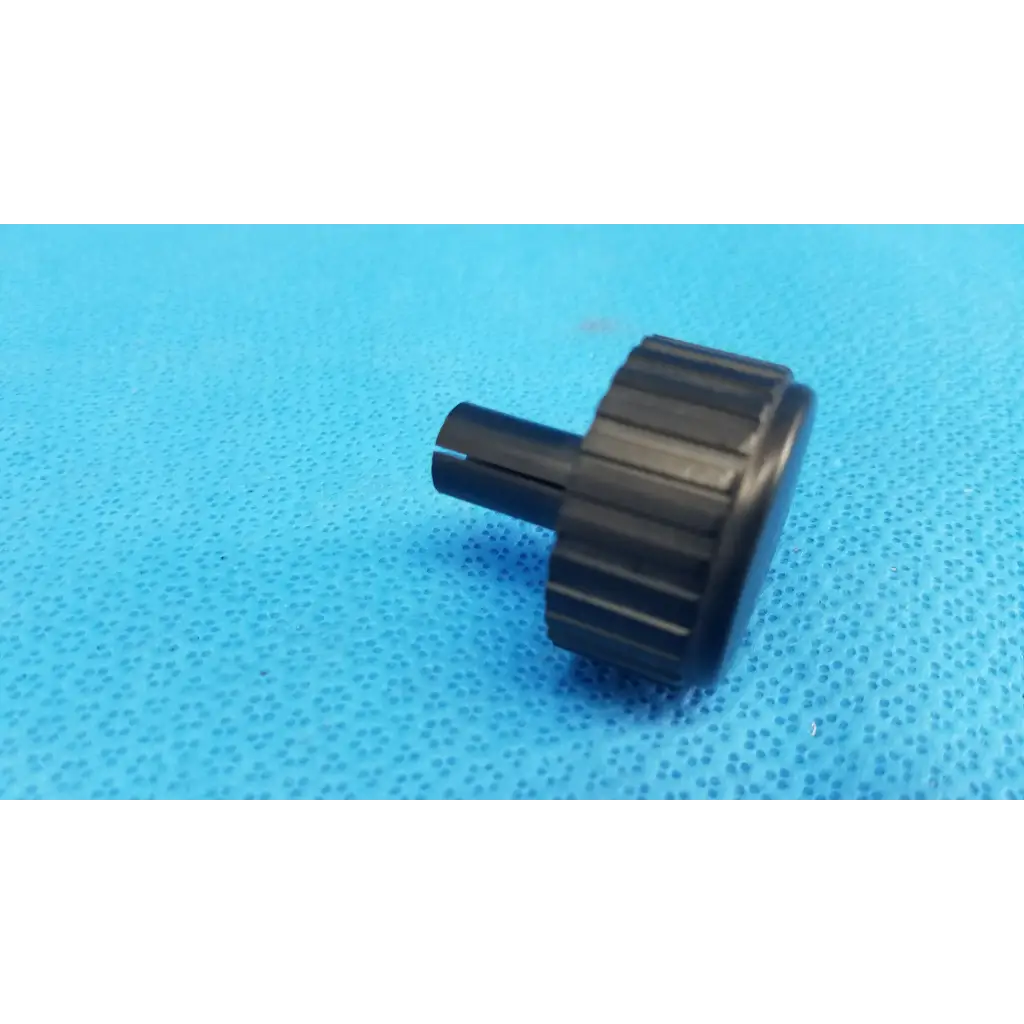 Black plastic external control panel extension dial adjustment knob with textured ridges and cylindrical stem for Topcon camera