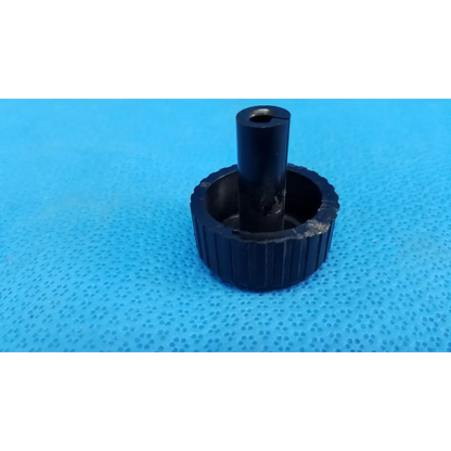 Black ribbed plastic adjustment knob with central hole for external control panel of topcon trc-nw8 retinal camera