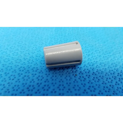 Gray cylindrical capacitor with grooves and smooth finish for external control panel rotary dial adjustment knob with indicator stripe