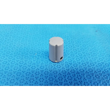 Gray cylindrical external control panel adjustment knob with indicator stripe and vertical slot for topcon control panel