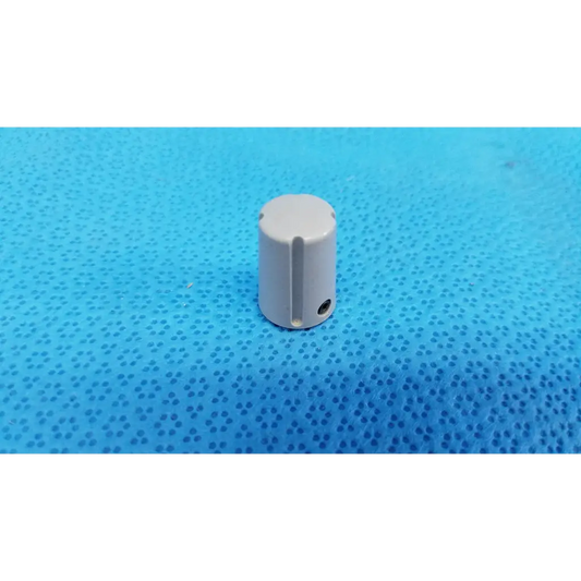 Gray cylindrical external control panel adjustment knob with indicator stripe and vertical slot for topcon control panel