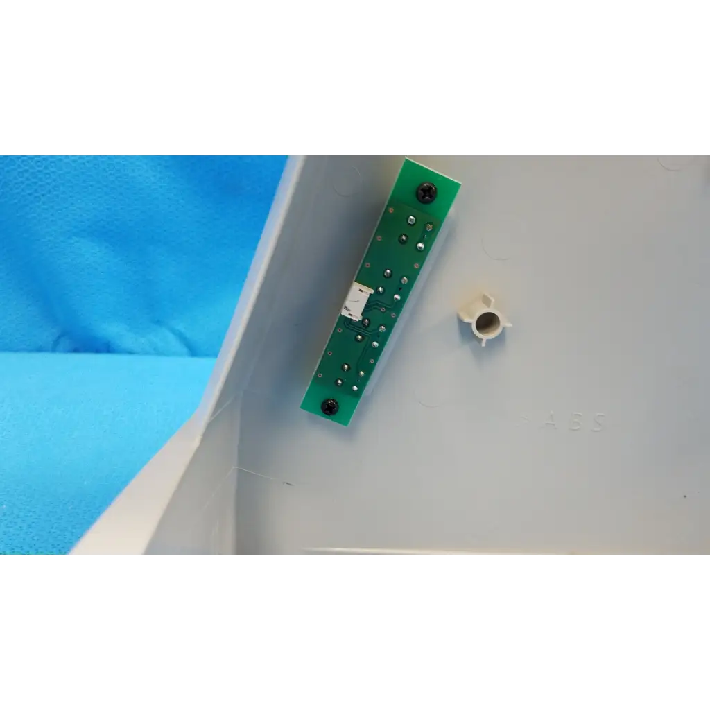 Green rectangular main optical body circuit board with silver solder points and black screws for topcon camera housing panel