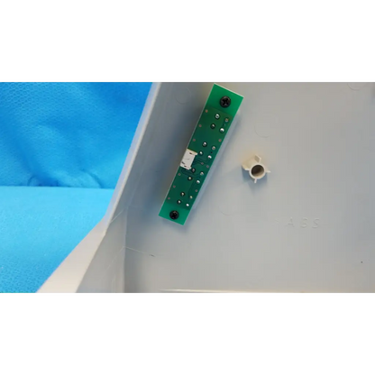 Green rectangular main optical body circuit board with silver solder points and black screws for topcon camera housing panel