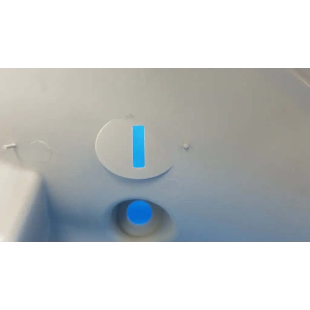 White circular button with blue vertical stripe and glowing blue circle on main optical body left side shroud housing panel
