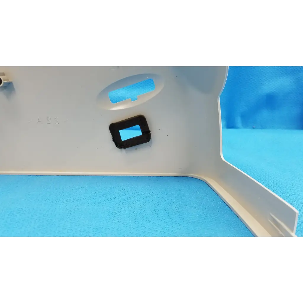 White plastic main optical body trim piece with black rubber grommet for left side shroud housing of Topcon TRC-NW8