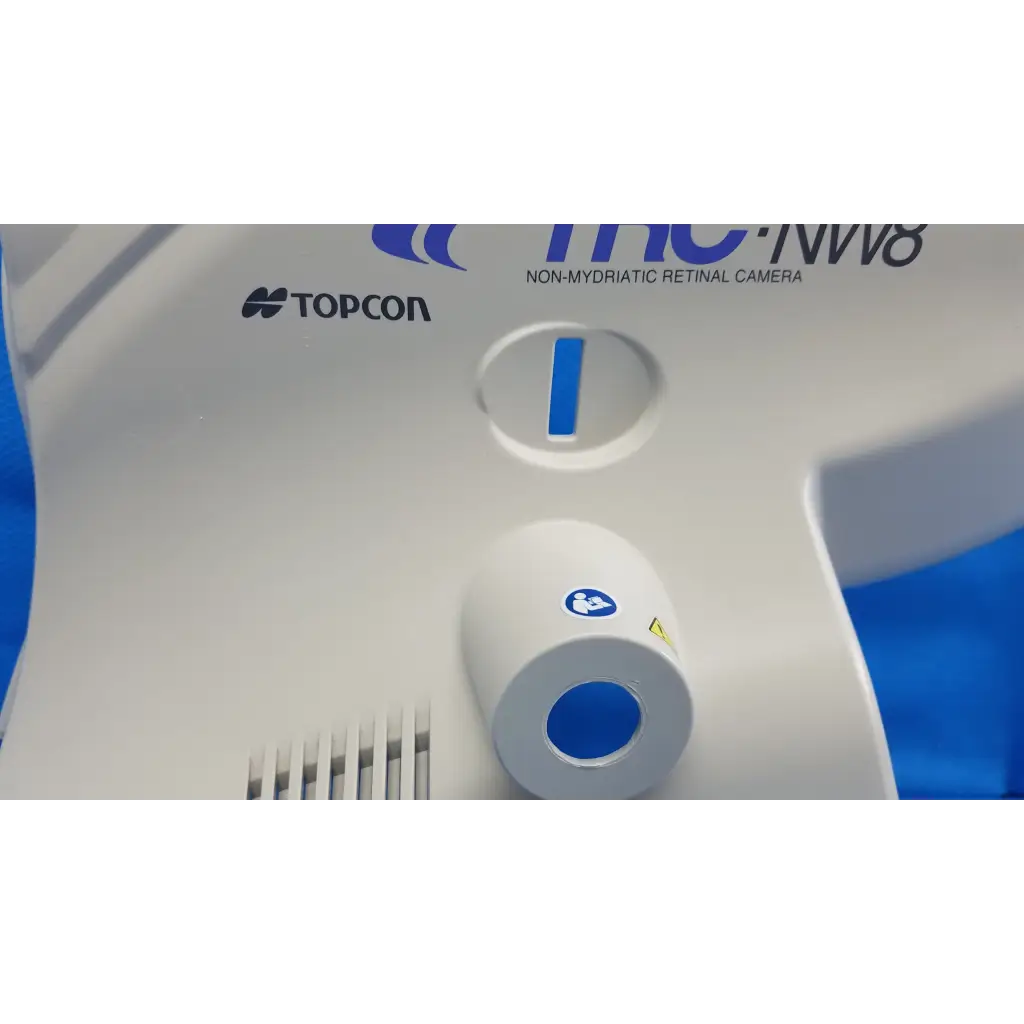 White and blue topcon tc-nw8 non-mydriatic retinal camera with main optical body left side shroud cover panel and osd ports