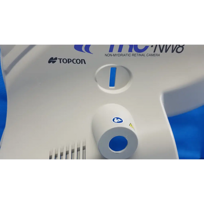 White and blue topcon tc-nw8 non-mydriatic retinal camera with main optical body left side shroud cover panel and osd ports