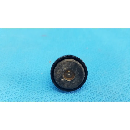 Black rubberized mechanical leveling screw foot with textured edge and central metallic ring for threaded bolt use