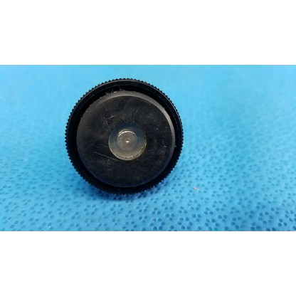 Black textured lens cap with central metallic ring for external mechanical leveling screw foot threaded bolt